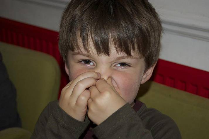 Kid holding nose